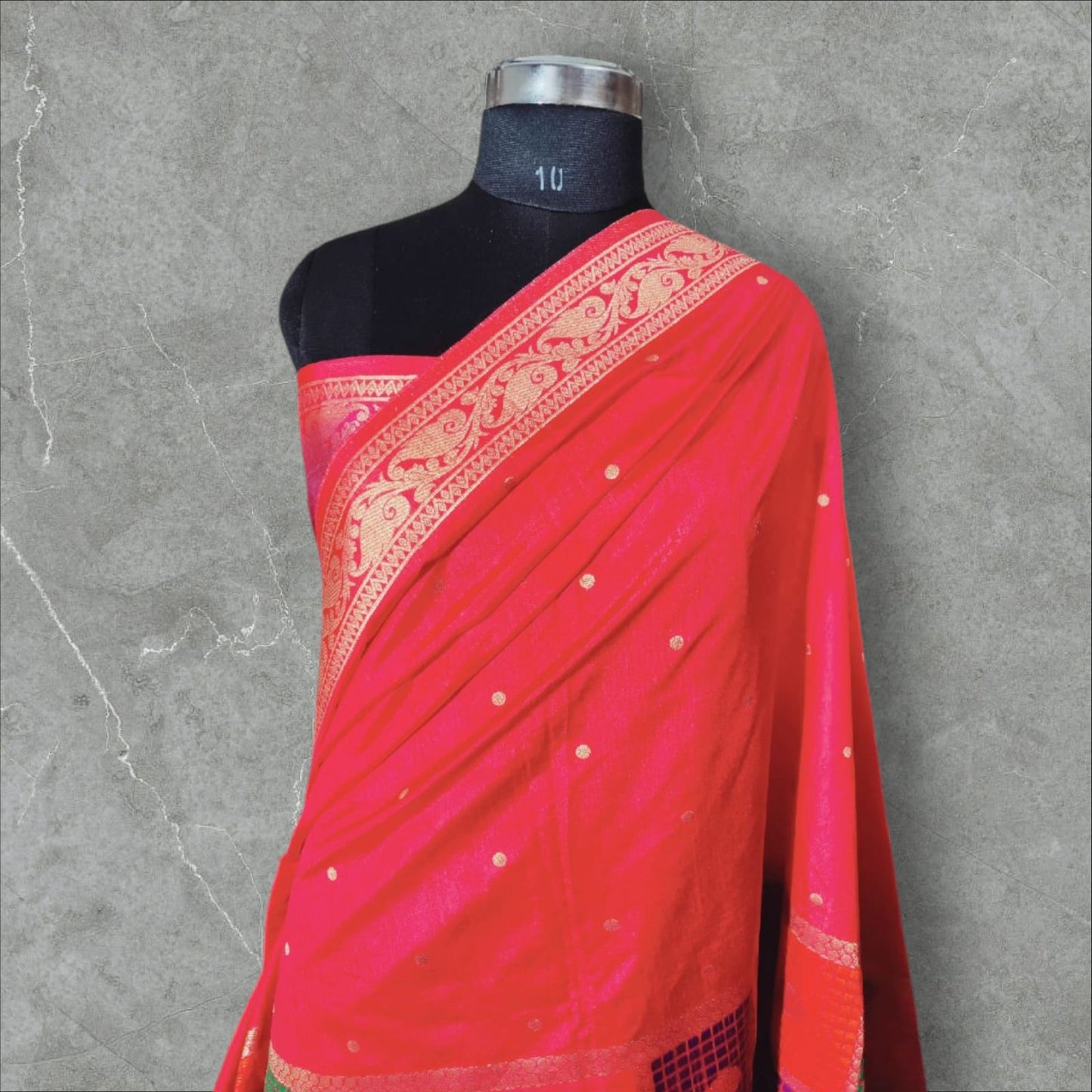 "Vibrant stawberry and gold Banarasi silk saree featuring intricate floral and geometric patterns with a rich, traditional border.