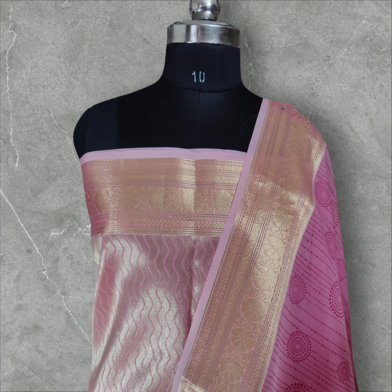 A beautiful organza silk saree in a soft pink color, featuring a lightweight, sheer texture with a subtle sheen. The saree drapes gracefully, adding an elegant and ethereal charm, perfect for weddings, festive occasions, and special events.