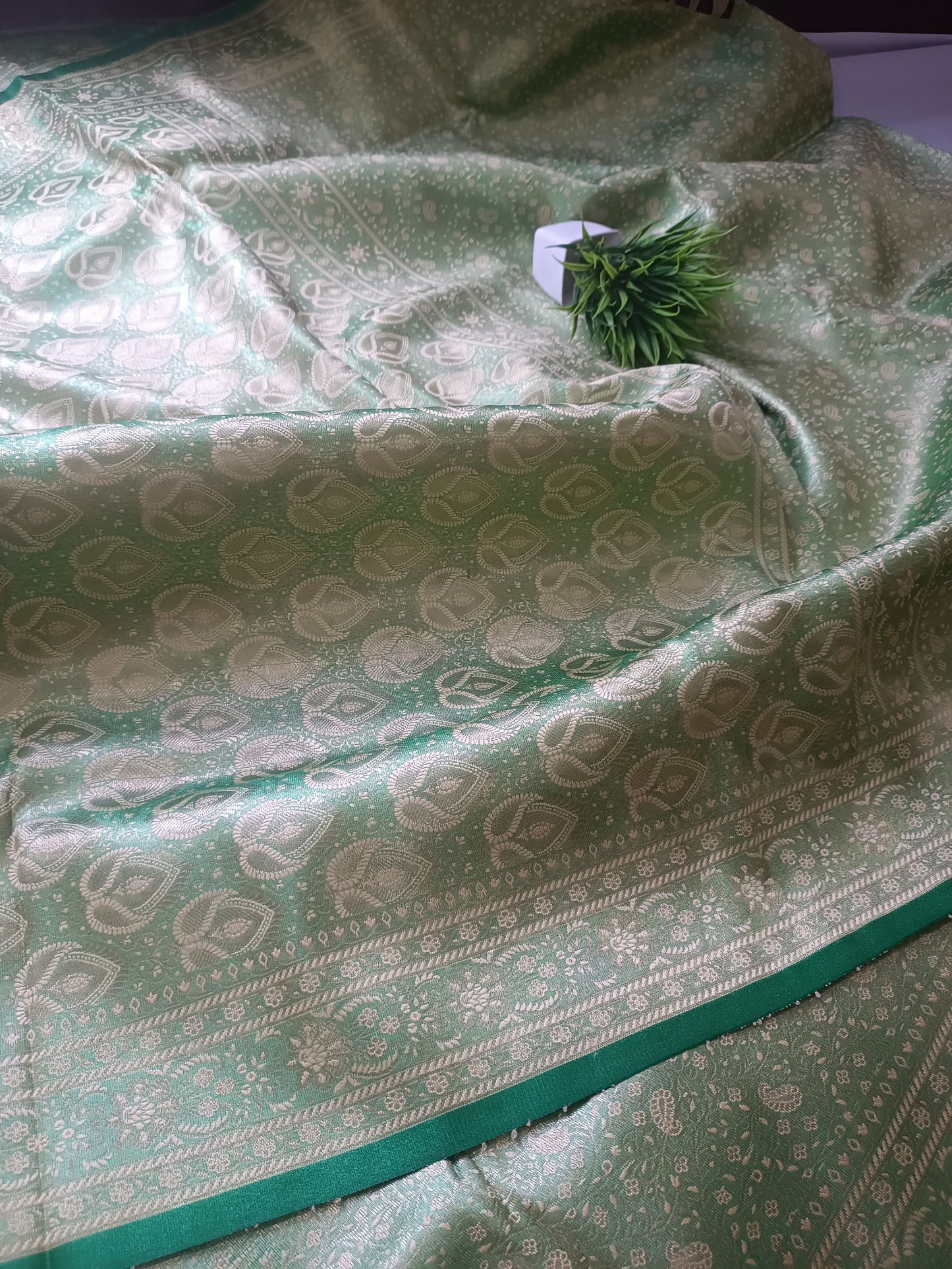 As a product expert, I recommend seagreen  Handbrush Tissue Silk Banarasi Saree for its unique and intricate handbrush technique, resulting in a stunning rust-colored saree. Made from high-quality tissue silk, this Banarasi saree is perfect for special occasions and offers a sophisticat dezainar saree 