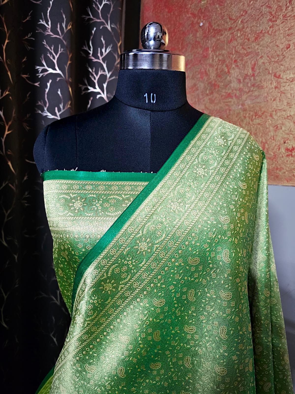 "Elegant green brocade silk saree with intricate golden zari weaving, perfect for weddings and festive occasions."