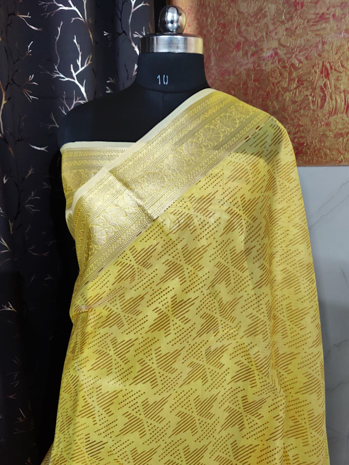 “Yellow organza silk saree with elegant hand brush painting, lightweight festive wear”