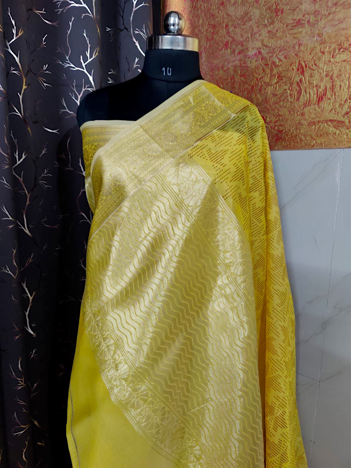 “Yellow organza silk saree with elegant hand brush painting, lightweight festive wear”