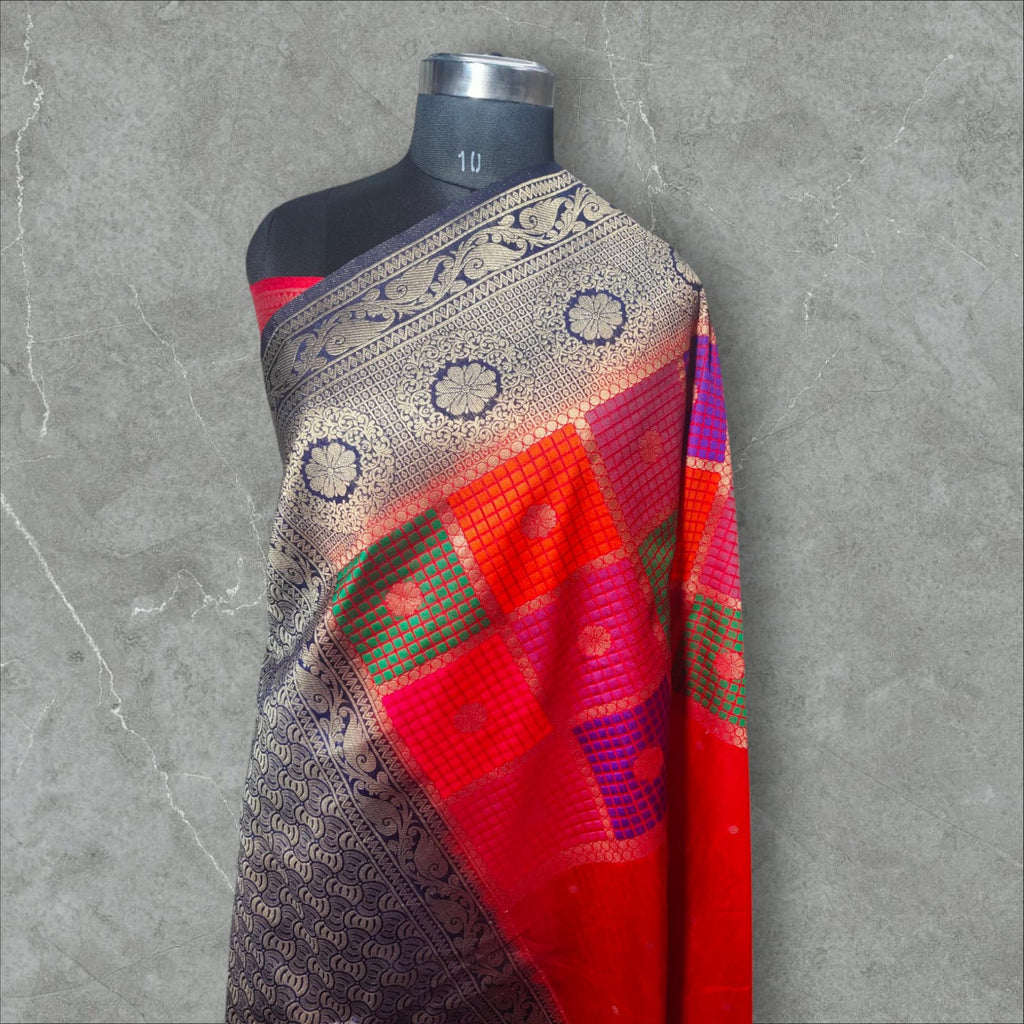 "Stunning Dupion Silk Saree with a vibrant navy blue and pink contrast, featuring intricate golden zari weaving, a checkered multi-color pattern, and a richly designed broad border, perfect for festive and traditional occasions."