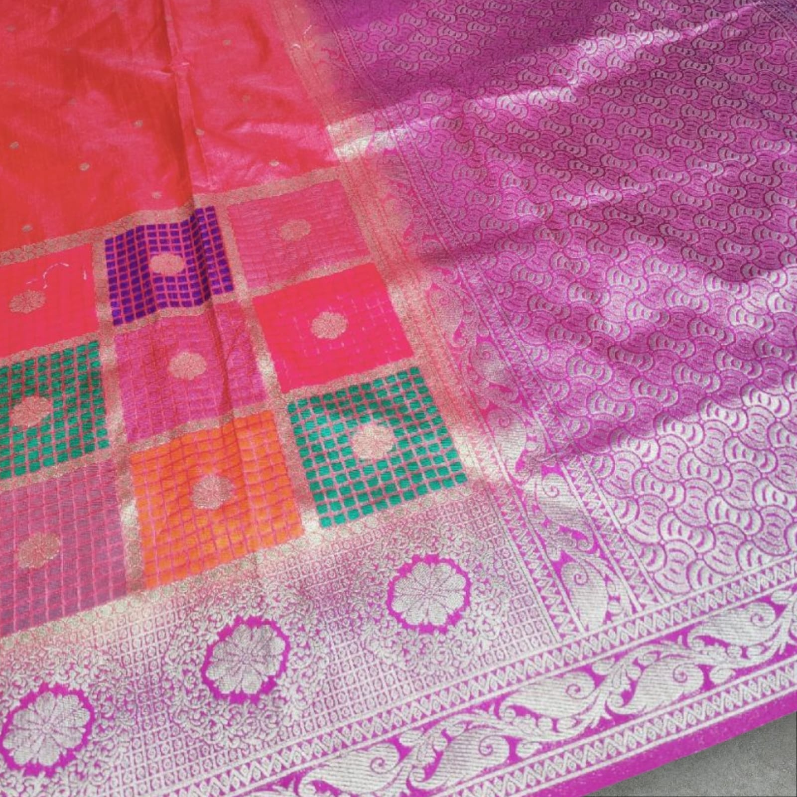 "Vibrant stawberry and gold Banarasi silk saree  featuring intricate floral and geometric patterns with a rich, traditional border.