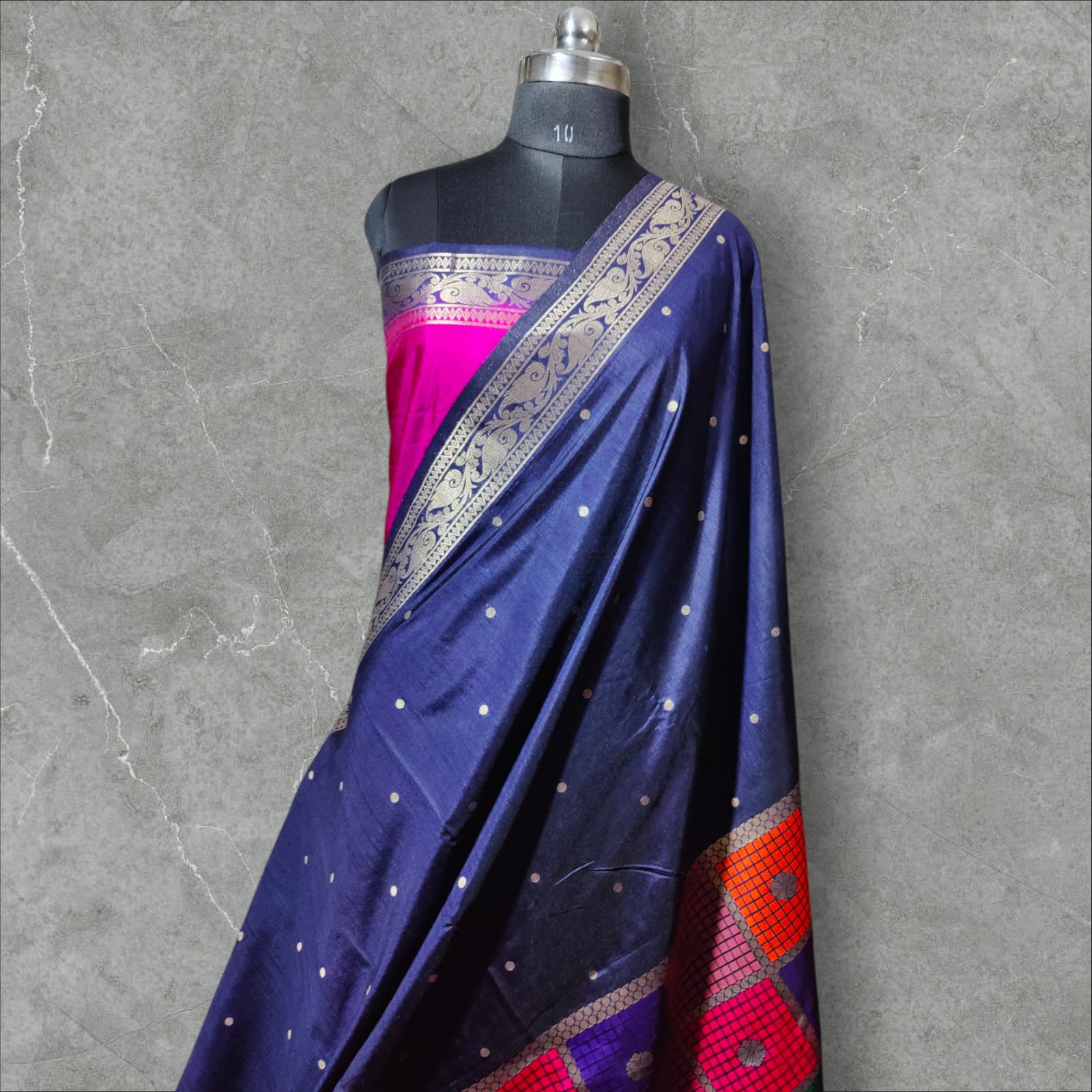"Stunning Dupion Silk Saree with a vibrant navy blue and pink contrast, featuring intricate golden zari weaving, a checkered multi-color pattern, and a richly designed broad border, perfect for festive and traditional occasions."