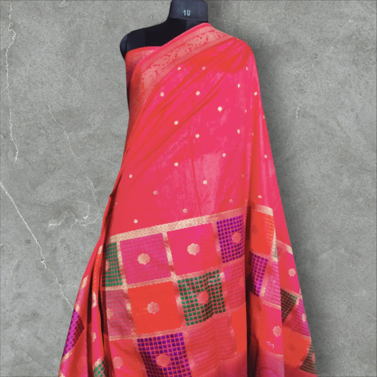 "Vibrant stawberry and gold Banarasi silk saree  featuring intricate floral and geometric patterns with a rich, traditional border.